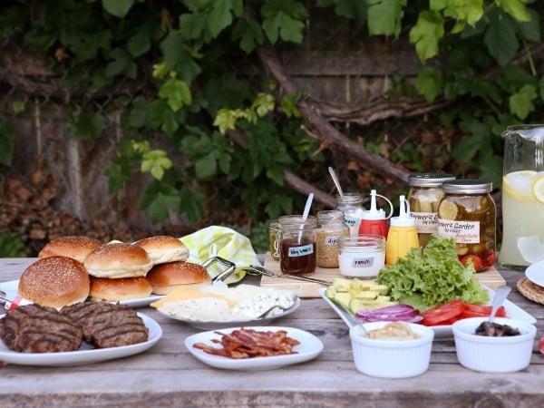 Here's a fun idea for your next backyard barbecue— a Build Your Own Burger Bar complete with the best burger patties and a buffet of toppings and condiments.