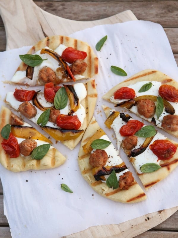 Grilled Pizzas with Sausage, Peppers, Roasted Tomatoes and Mozzarella from completelydelicious.com