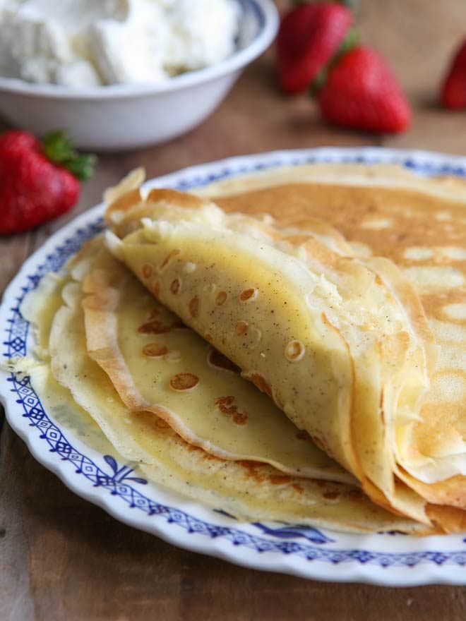 Homemade crepes to be served with strawberries and cream