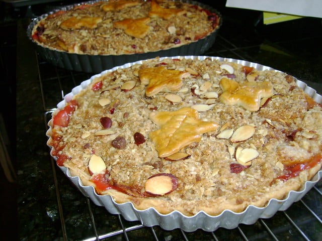 Apple pear cranberry crumble tart finished with a leaf pie cut out.