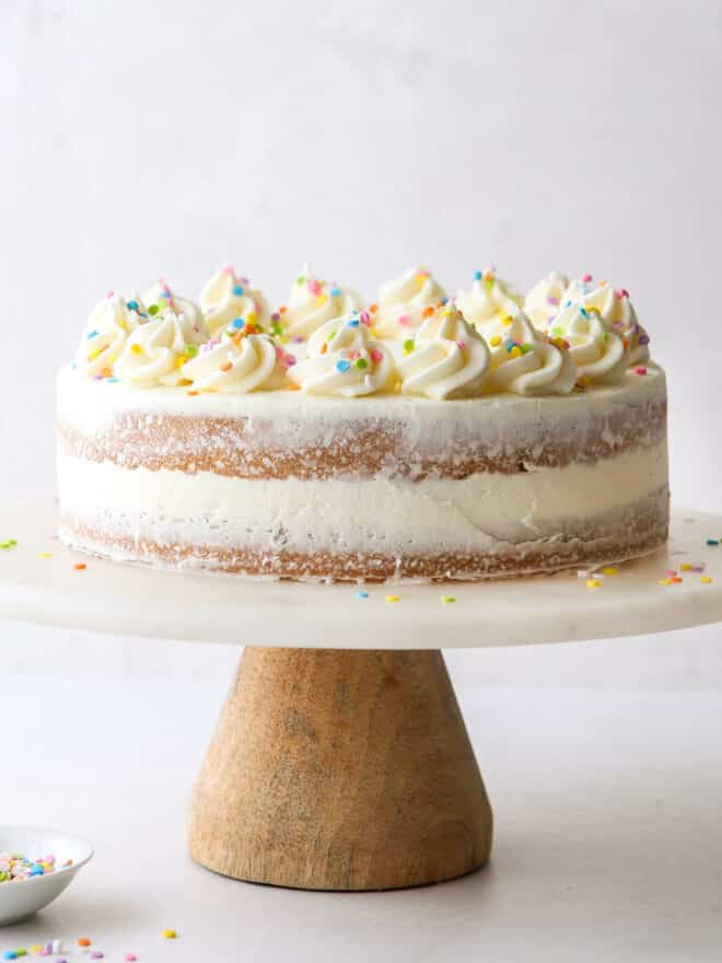 assembled sugar cookie layer cake on a cake stand