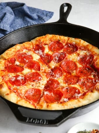 Pepperoni pizza baked in cast iron skillet.
