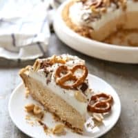 Peanut Butter Mousse Pie with Marshmallow Whipped Cream and Pretzel Crust | completelydelicious.com