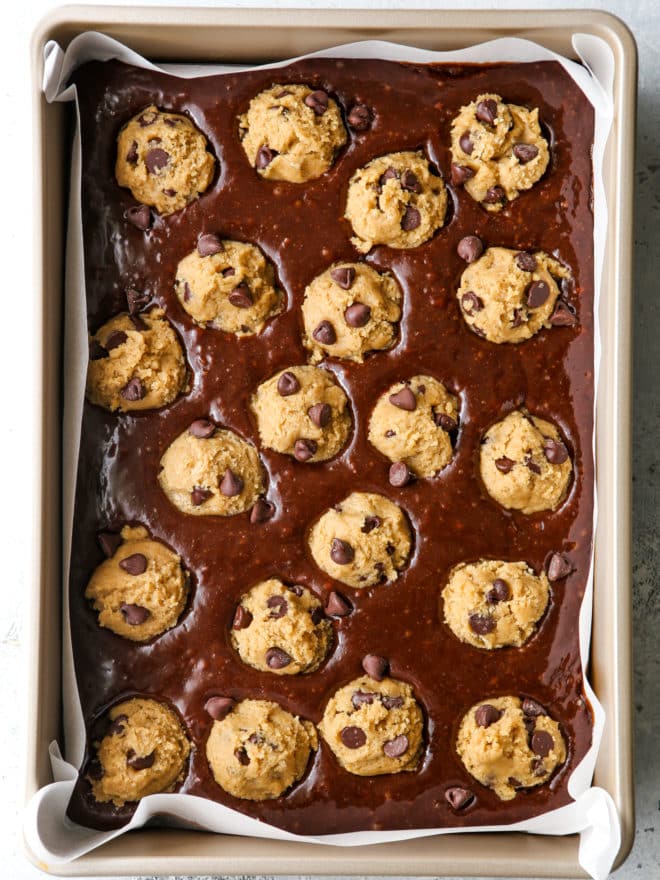 cookie dough balls in brownie batter in pan