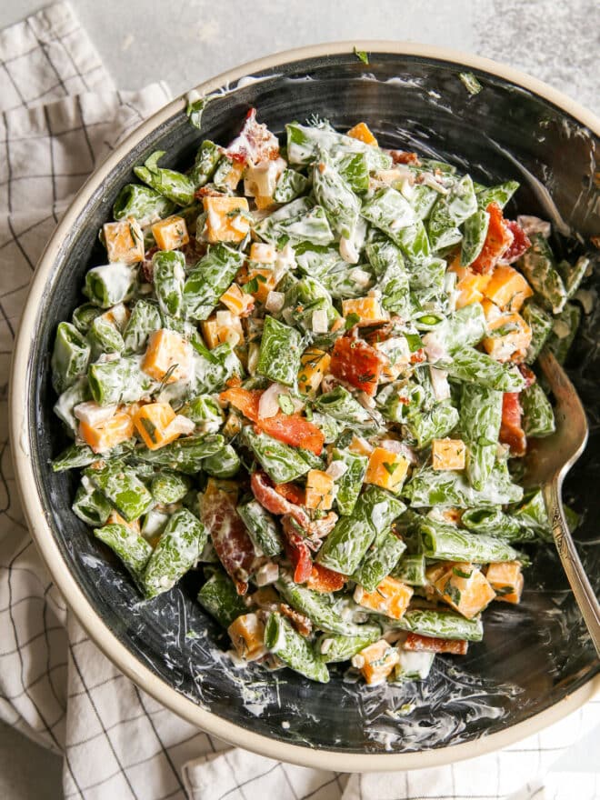 mixing the sugar snap pea salad