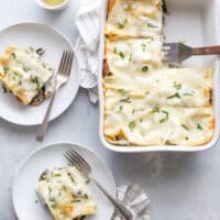 Chicken, mushroom, and spinach lasagna in a cheesy white sauce from completelydelicious.com