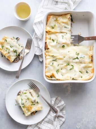 Chicken, mushroom, and spinach lasagna in a cheesy white sauce from completelydelicious.com