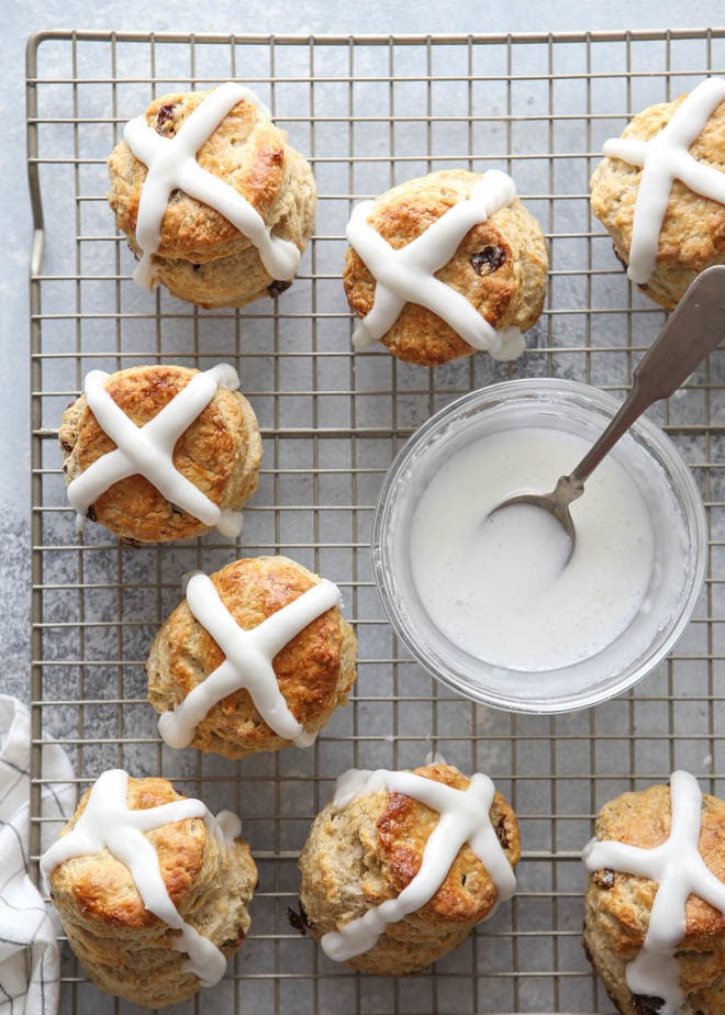 Pouring the glaze on these fun and flavorful hot cross biscuits