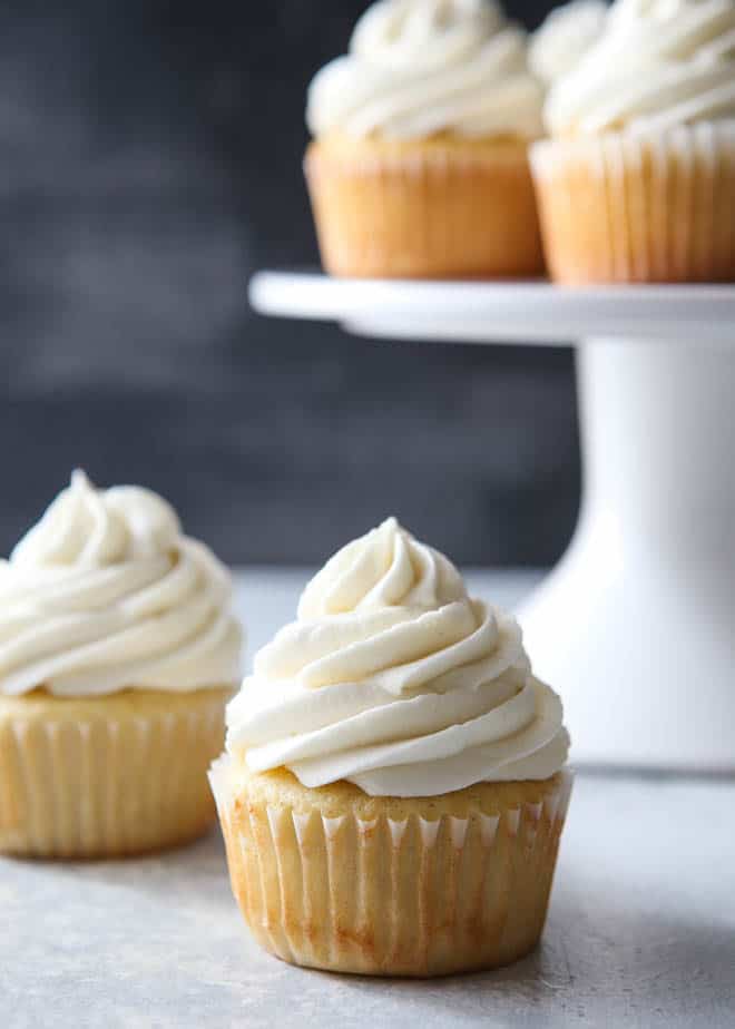 The fluffiest and creamiest vanilla frosting, piled on a cupcake