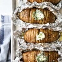 "Baked" potatoes cooked on the grill and served with chive butter