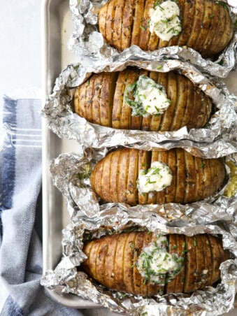 "Baked" potatoes cooked on the grill and served with chive butter