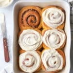 Pumpkin cinnamon rolls filled with a pumpkin spice and pecans and topped with a cream cheese frosting