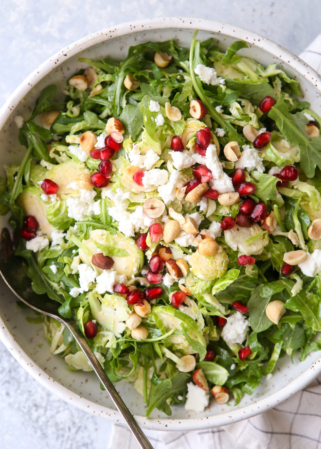 Shredded Brussels sprouts and arugula salad with feta, hazelnuts and pomegranate