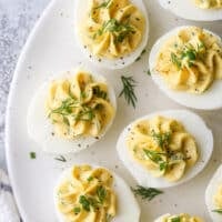 Classic deviled eggs made with mayonnaise, mustard and fresh chives and dill are a simple but irresistible appetizer.