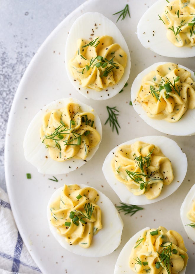 Classic deviled eggs made with mayonnaise, mustard and fresh chives and dill are a simple but irresistible appetizer.