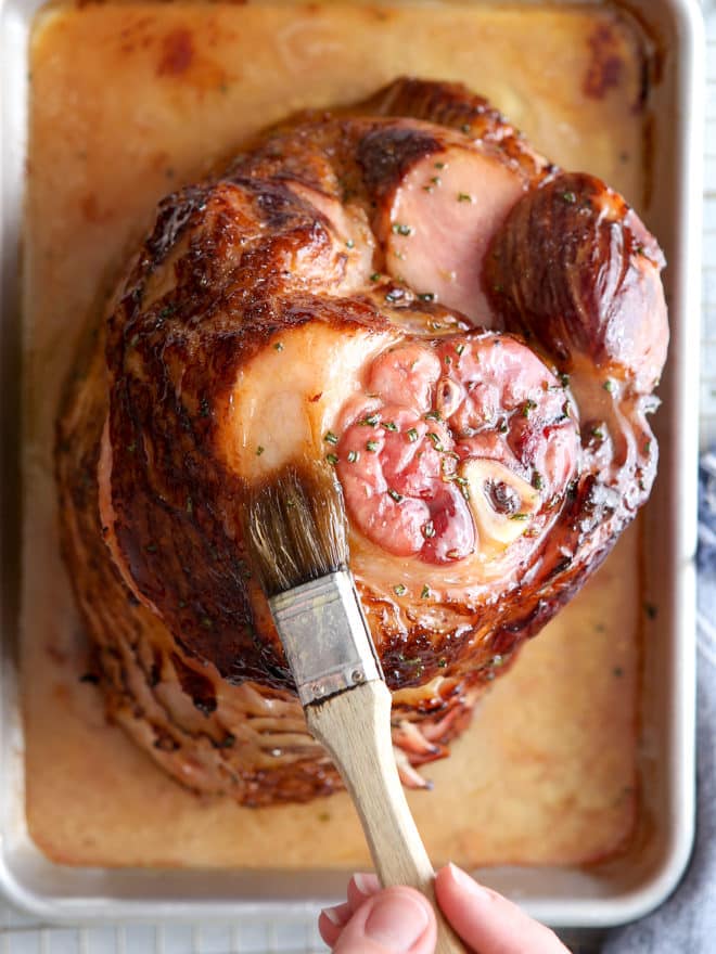 This honey-butter glazed ham recipe made with honey, butter, garlic, and rosemary is sweet and flavorful and only requires a few minutes of prep!