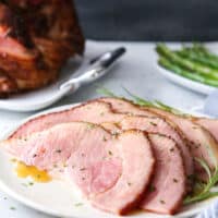 This honey-butter glazed ham recipe made with honey, butter, garlic, and rosemary is sweet and flavorful and only requires a few minutes of prep!