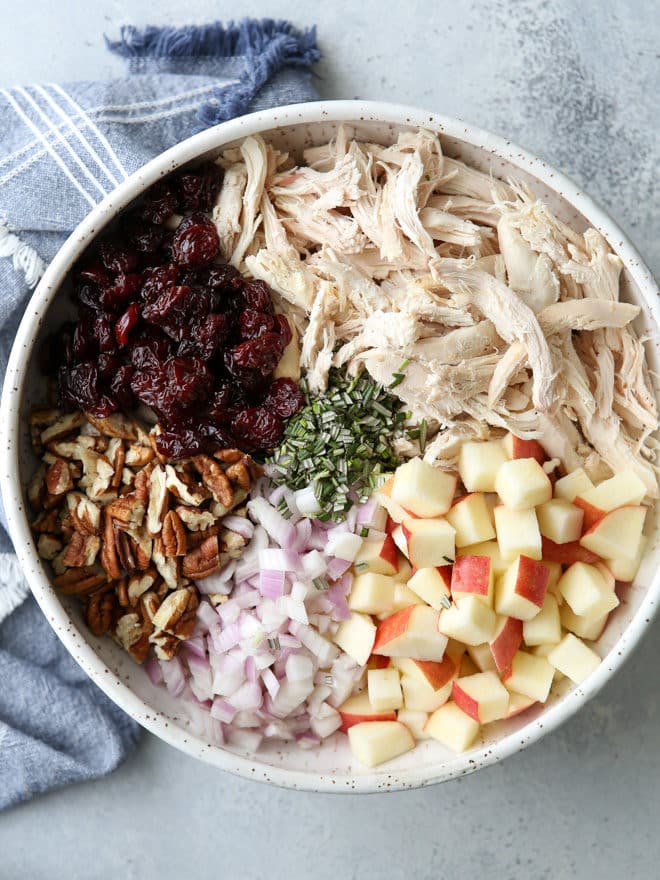 This delicious chicken salad is filled with shredded chicken, chopped pecans, diced apples, dried cherries, and a rosemary scented dressing.