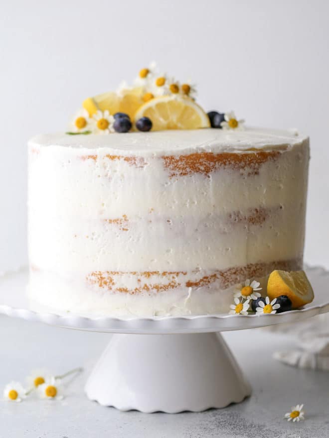 This light and tender lemon blueberry cake is filled with fresh blueberry preserves and frosted with silky lemon buttercream.