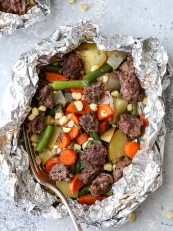 These beef and veggie tin foil dinners are an entire meal wrapped up in foil and cooked on the grill, over a fire, or in the oven.