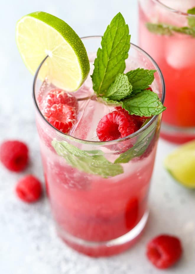 This refreshing raspberry mojito cocktail made with rum, mint, lime, and fresh raspberries is perfect for summer sipping!