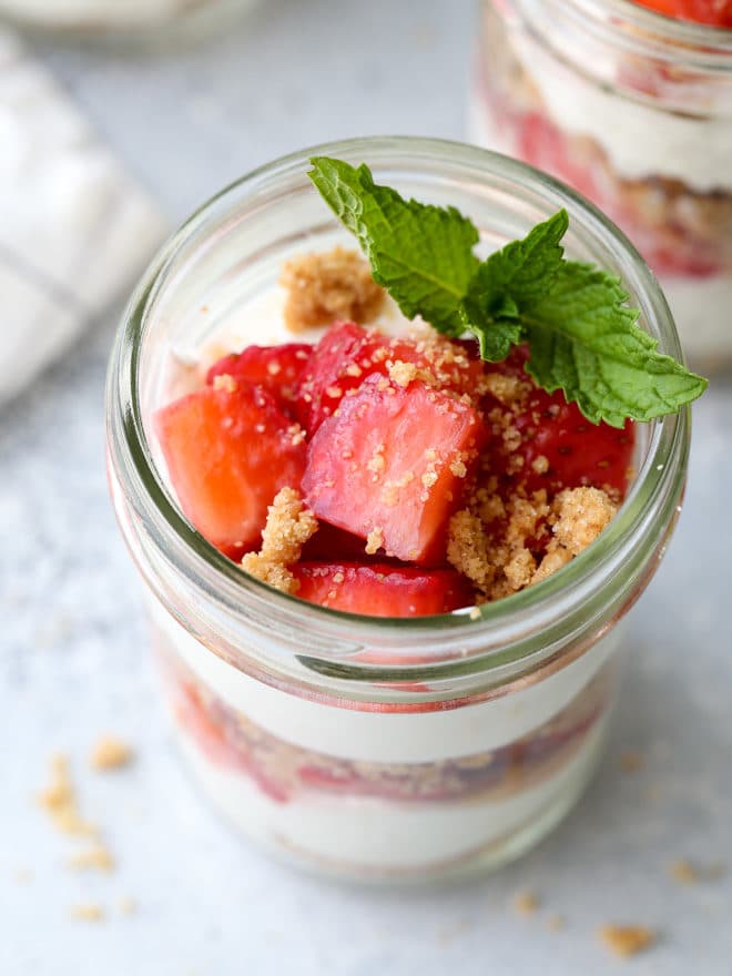 Layers of fresh strawberries, yogurt whipped cream, and graham cracker crumble make up these adorable and irresistible parfaits.
