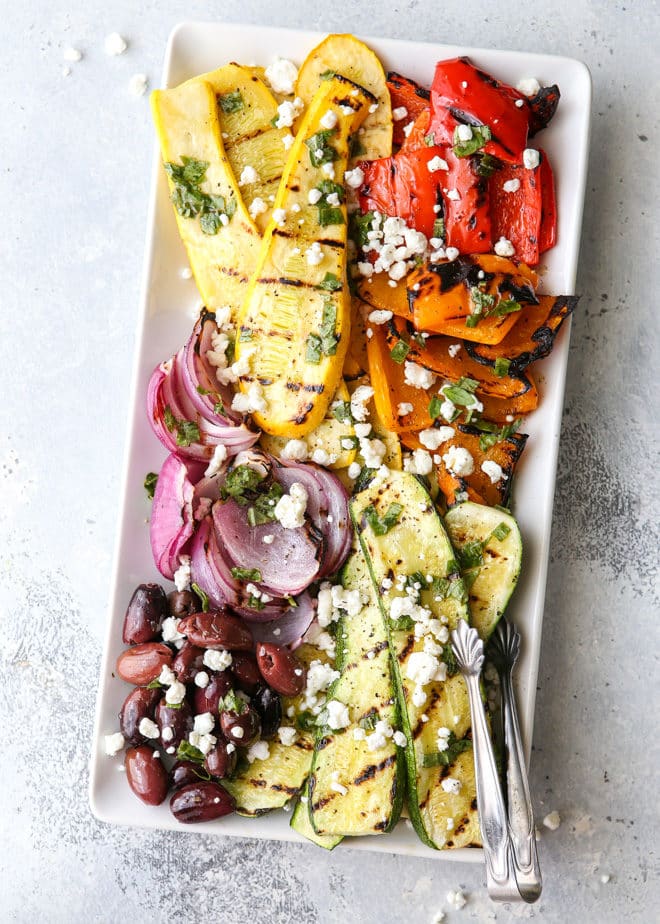 This grilled vegetable antipasto platter of zucchini, summer squash, red onion, bell peppers caramelized on the grill and served with kalamata olives, goat cheese and basil dressing is exactly what your next summer dinner party needs!