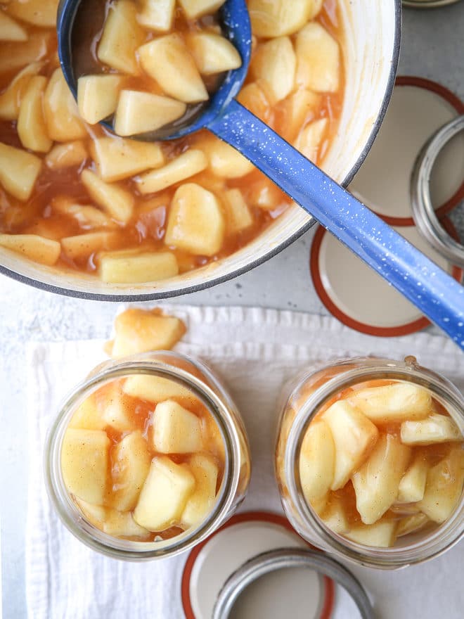 Ladle apple pie filling into jars