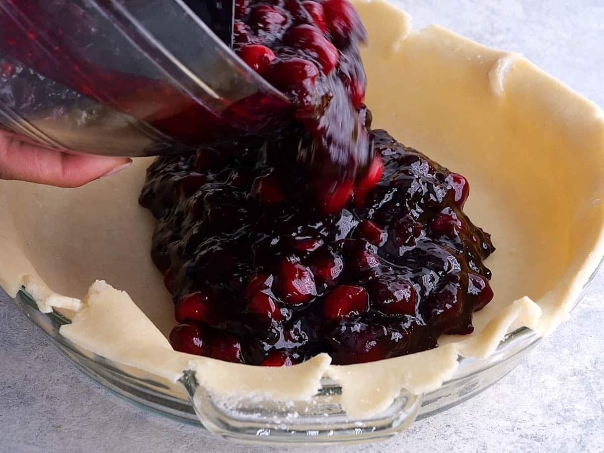 pouring filling into pie crust
