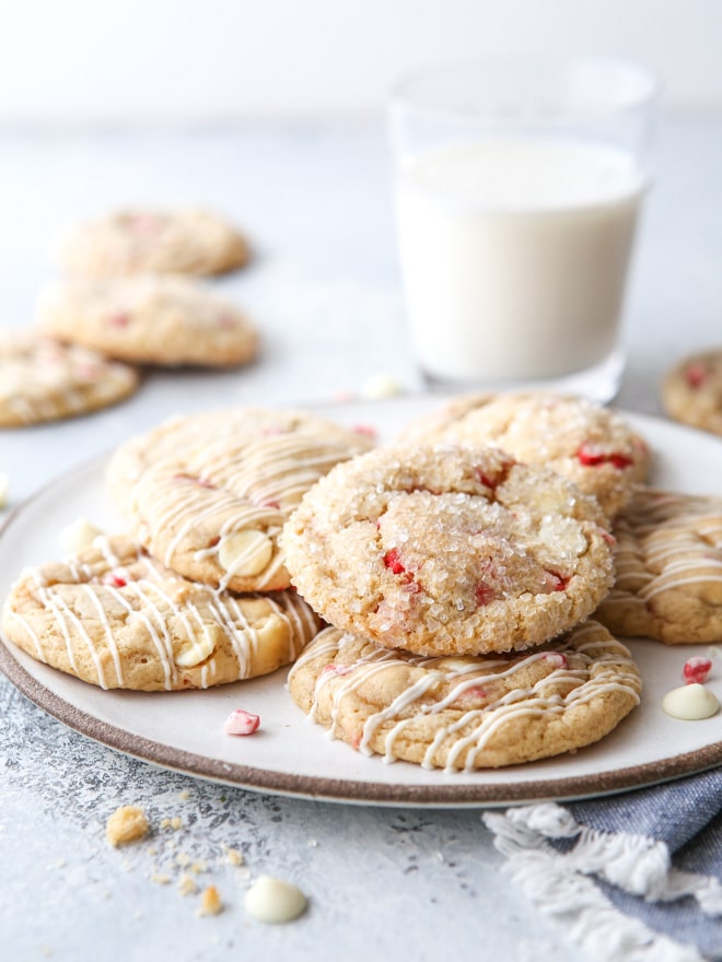 peppermint white chocolate chip cookies on a plate with glass or milk