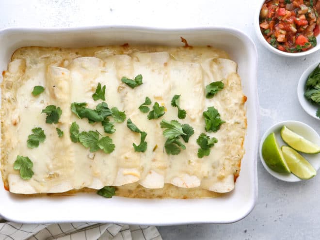 These sour cream chicken enchiladas are a family favorite! They're cheesy, creamy, and made completely from-scratch!