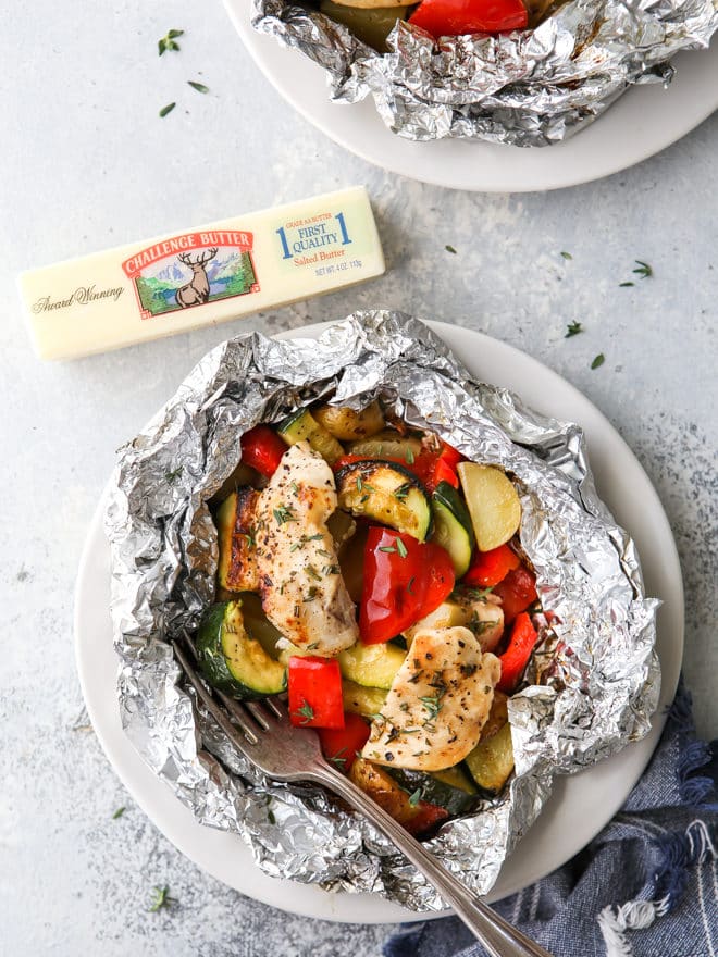 These delicious chicken and veggie tin foil dinners are a complete and hearty meal wrapped up in foil and cooked over a fire, on the grill, or in the oven.