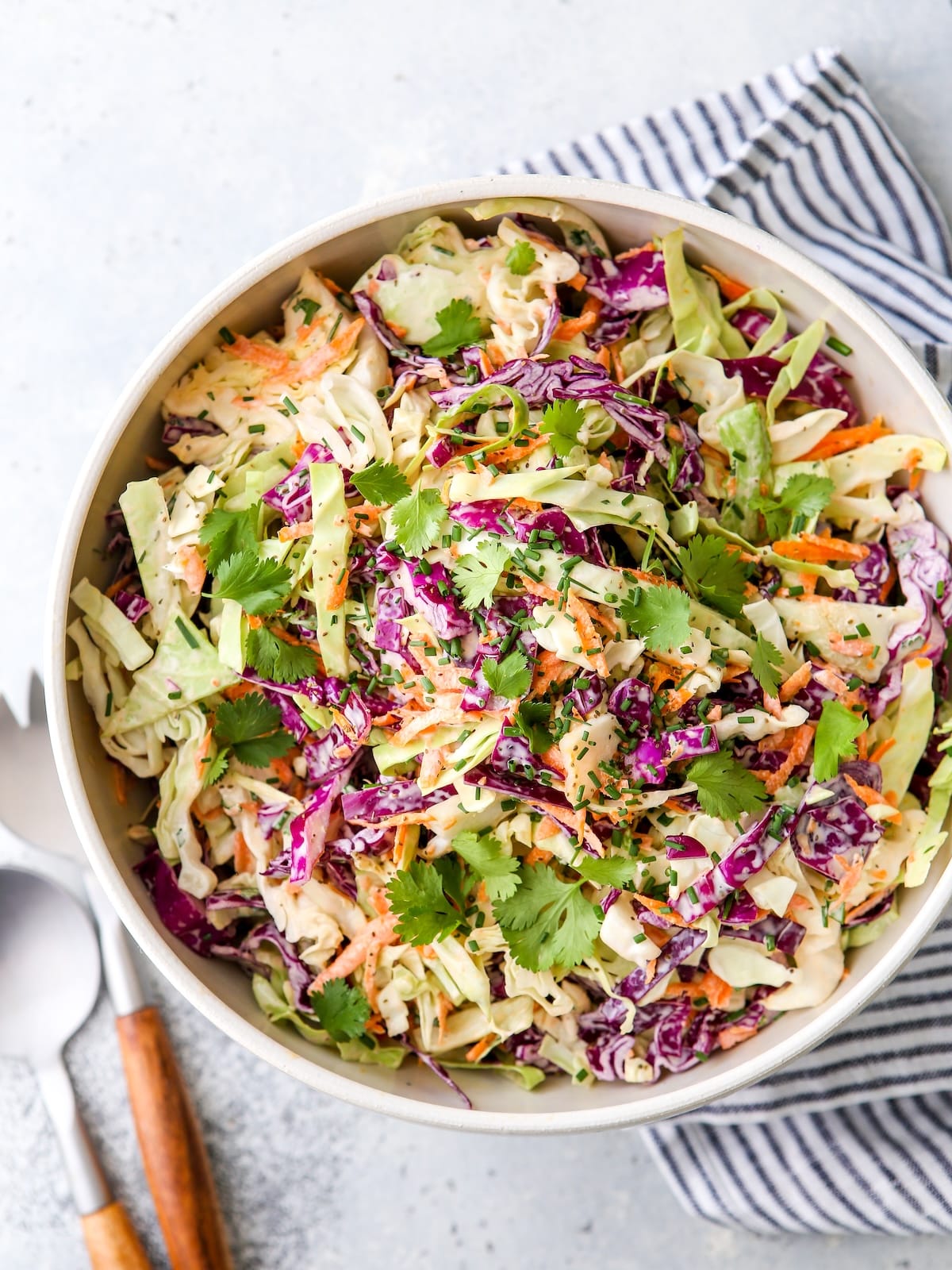 This is the easiest classic coleslaw filled with cabbage, carrots, chives, cilantro and a creamy mayo dressing.