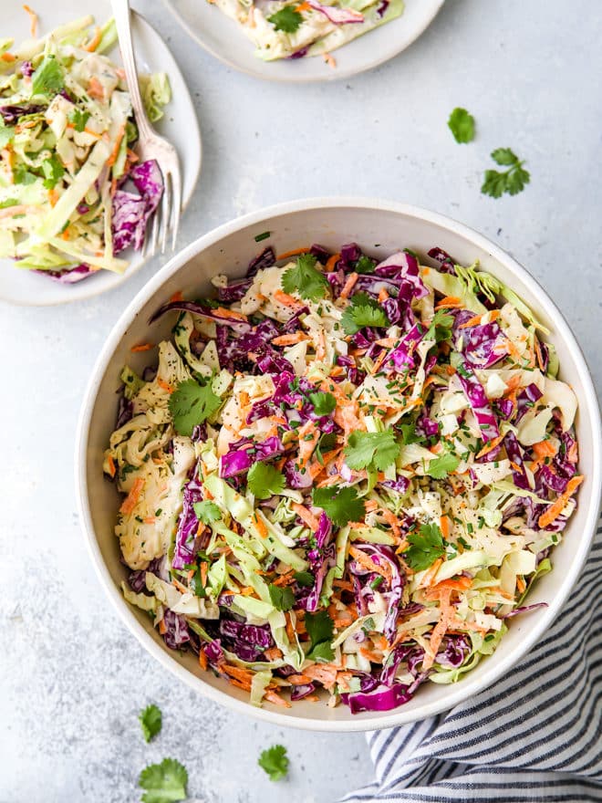 This is the easiest classic coleslaw filled with cabbage, carrots, chives, cilantro and a creamy mayo dressing.