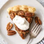 pecan pie piece with whipped cream on top