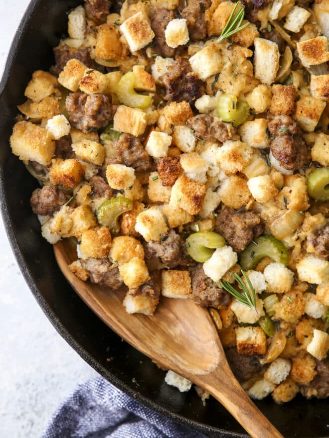 spoon in skillet stovetop sausage stuffing close-up