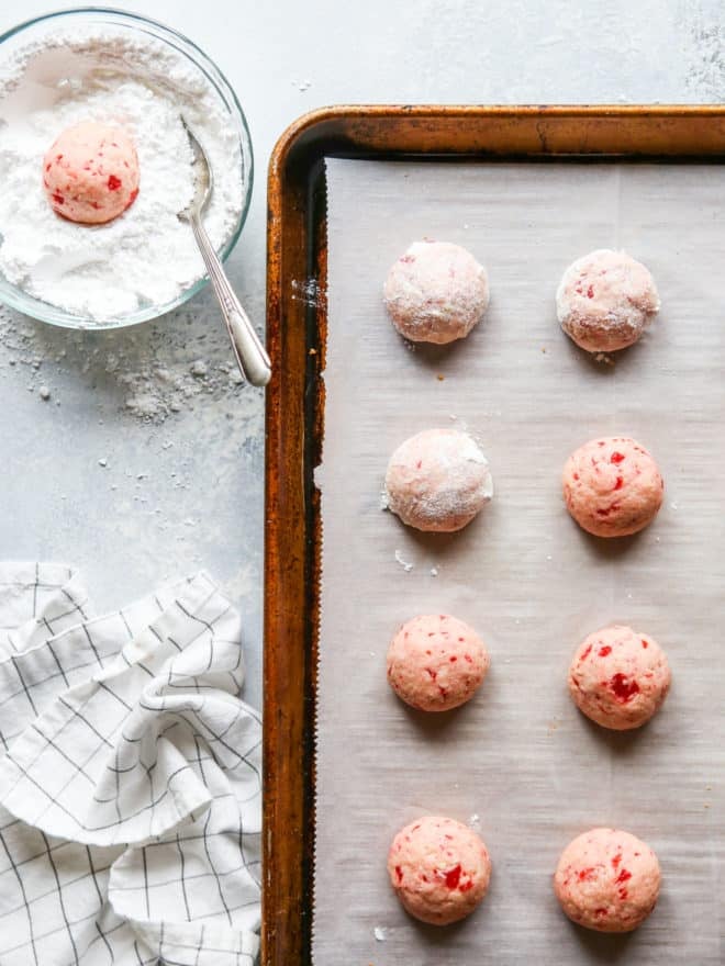 baked cherry almond snowballs dipped in powdered sugar