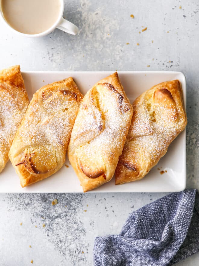 cream cheese danishes on a plate with a cup of coffee