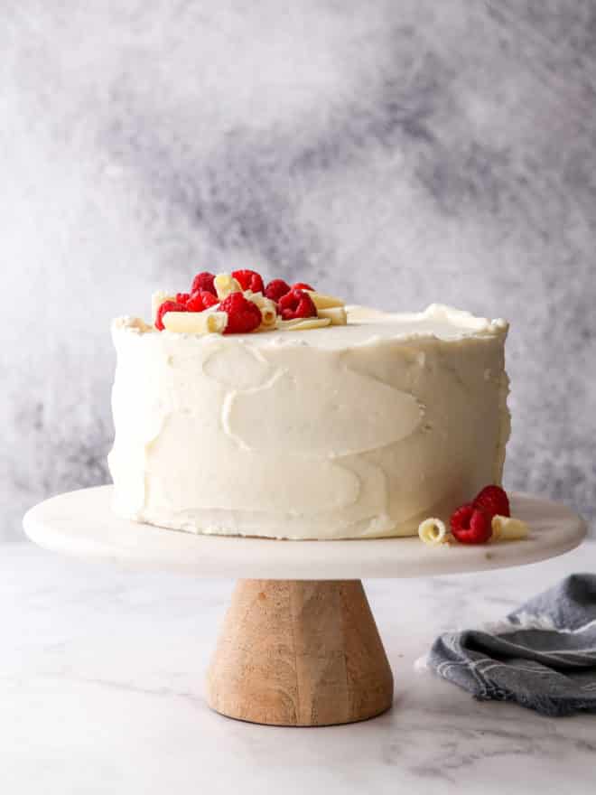 raspberry white chocolate cake on a cake stand