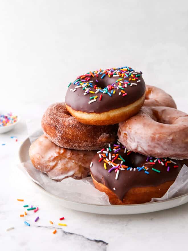 yeast-raised doughnuts stacked on a plate