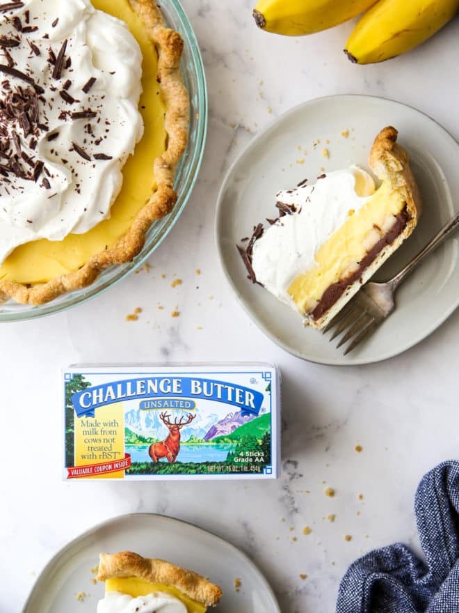chocolate bottom banana cream pie sliced on plates with box of Challenge Butter