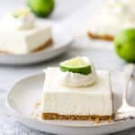 a slice of lime cheesecake bars on a plate with a fork