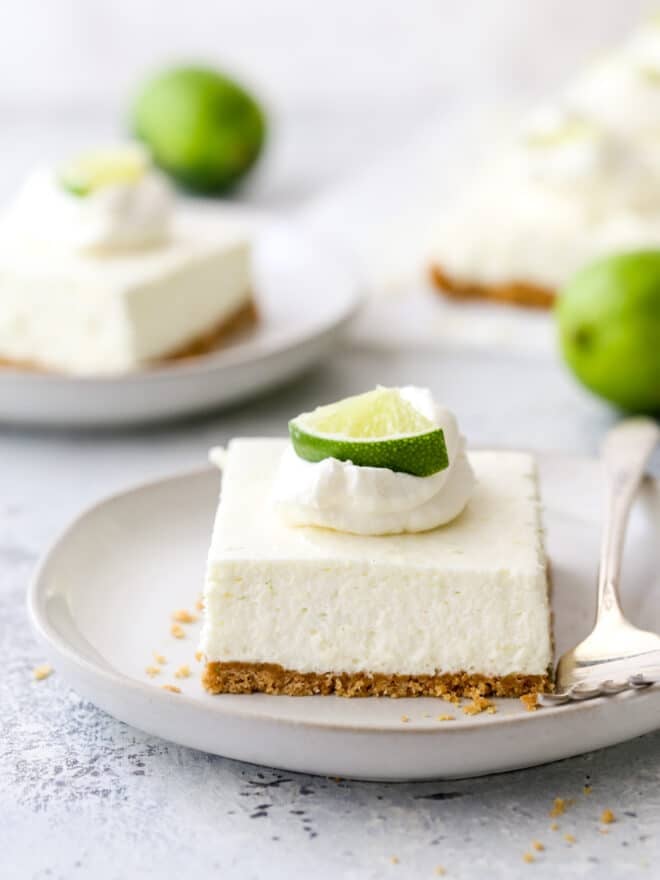 a slice of lime cheesecake bars on a plate with a fork
