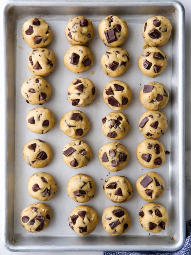 rounds of chocolate chip cookie dough on a sheet pan