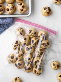 rounds of chocolate chip cookie dough in a ziplock bag, with some on the side