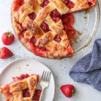 strawberry rhubarb pie with a slice on a plate