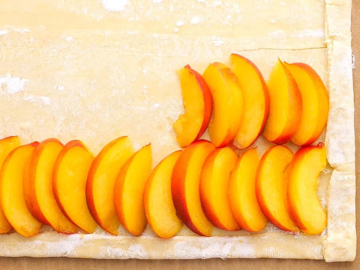 layering fruit on puff pastry