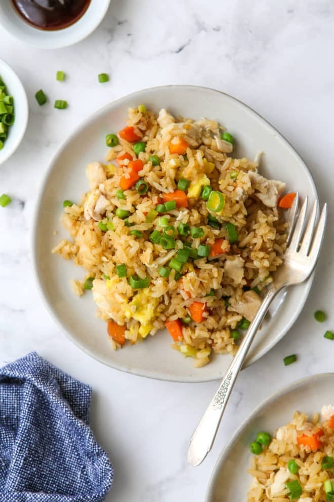 chicken fried rice on plates with a fork