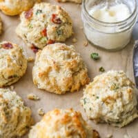 buttermilk drop biscuits with different mixins on a sheet of parchment closeup