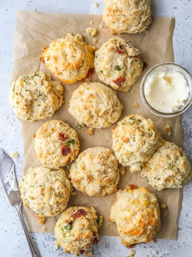 buttermilk drop biscuits with different mixins on a sheet of parchment